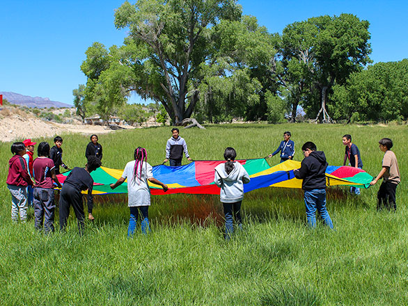 campers playing with a parachute
