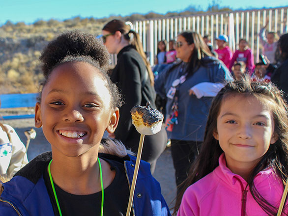 two campers toasting marshmallows