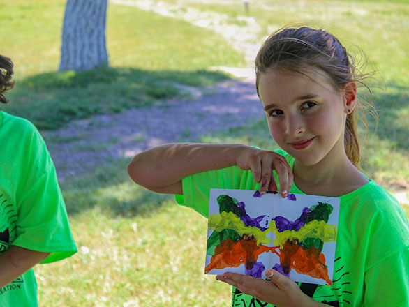 camper showing off their artwork