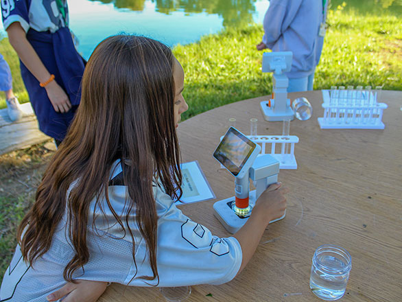 camper looking through microscope