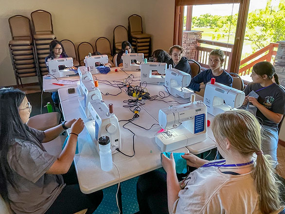 campers learning how to use sewing machines