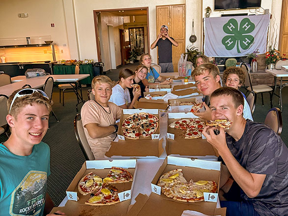 group of campers eating pizza