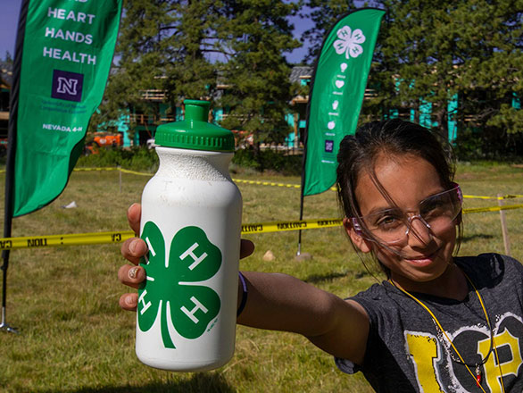camper showing off their 4-H water bottle