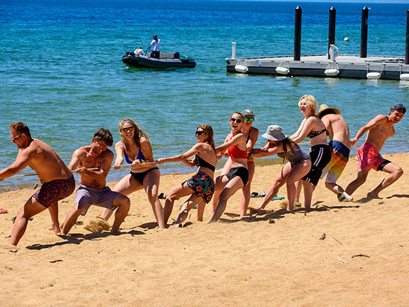 camper playing tug-a-war on the beach