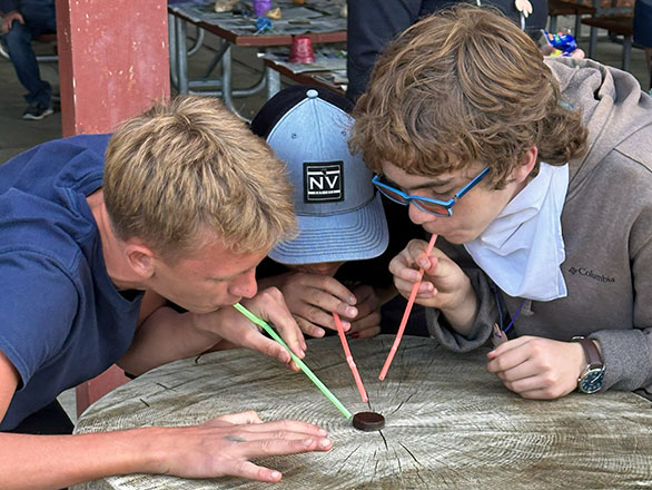 campers play game using straws
