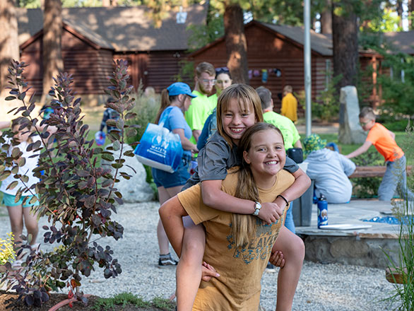 campers giving piggy back rides to each other