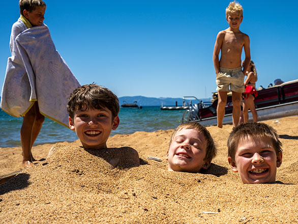 campers buried up to their necks in sand