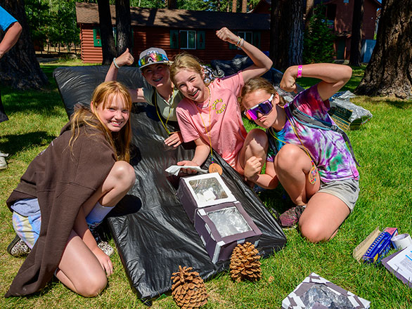 campers showing off their solar oven