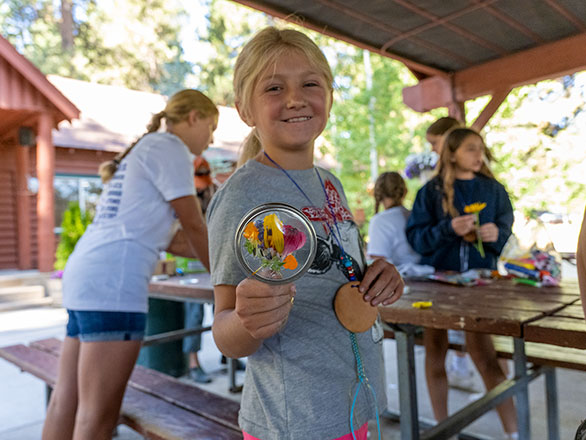 camper showing off their pressed flower sun catcher