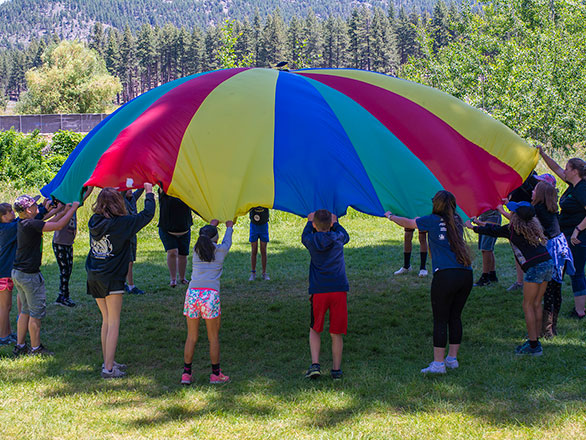 campers playing with parachute