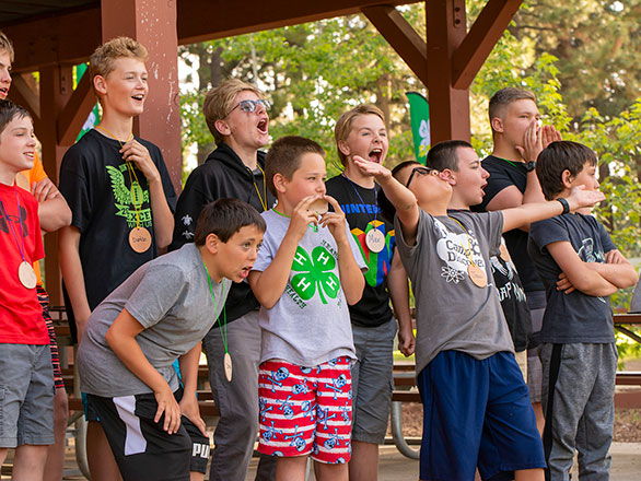 campers gathered around the piano singing songs
