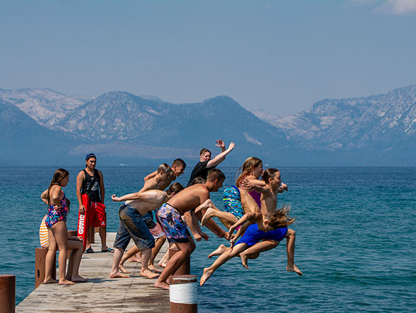 campers jumping off the pier into lake tahoe